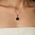 Crafted in 925 sterling silver, this striking pendant showcases a captivating 7.91 carat Black Star gemstone in a classic...