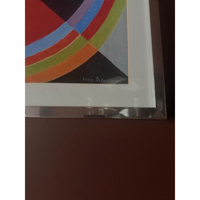 A striking vintage framed art print after Sonia Delaunay’s Rythme couleur no. 1076, originally created in 1939. The...