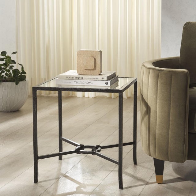 Introducing the Tauri Forged Metal Square Accent Table - a stunning blend of artistic flair and bold, industrial design....