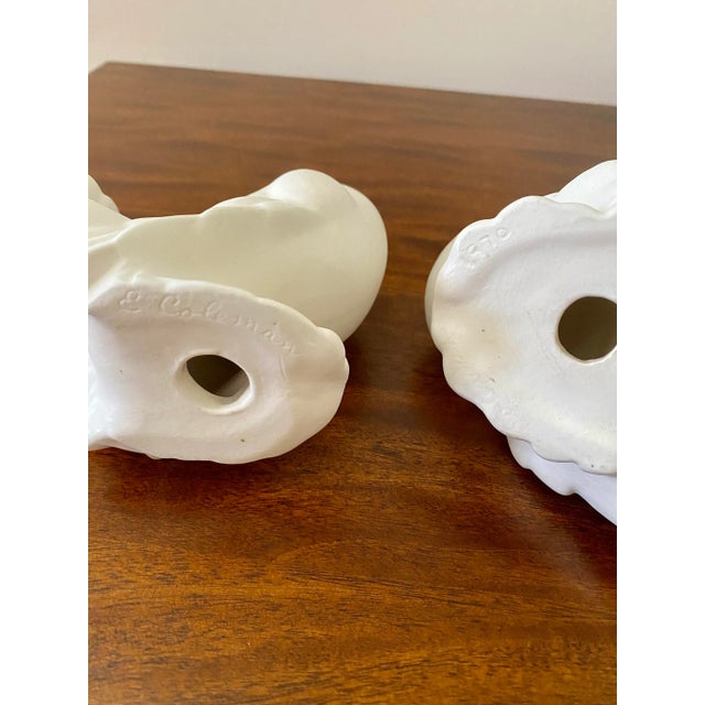 Stunning pair! These pair of white doves are signed E Coleman, 1970. There is some staining consistent with age.
