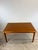 This Danish modern dining table features pressed wood construction, teak veneer with original finish, two draw leafs and...