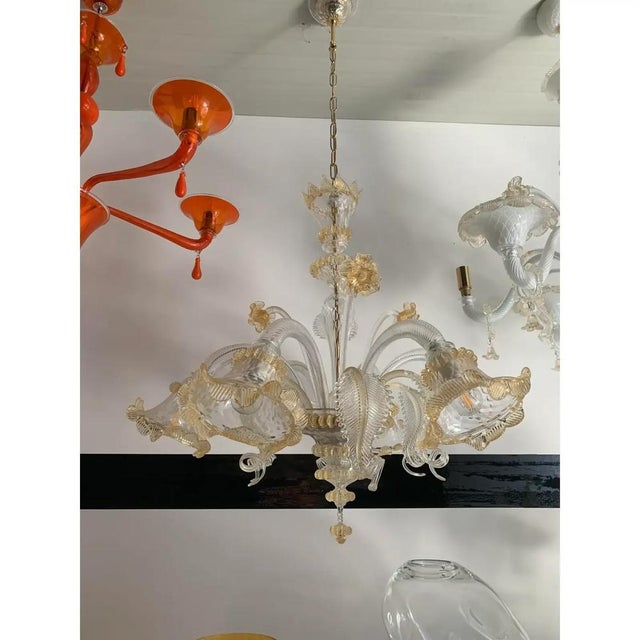 Classical transparent and gold murano glass chandelier with flowers and leaves. traditional piece of italian art of...