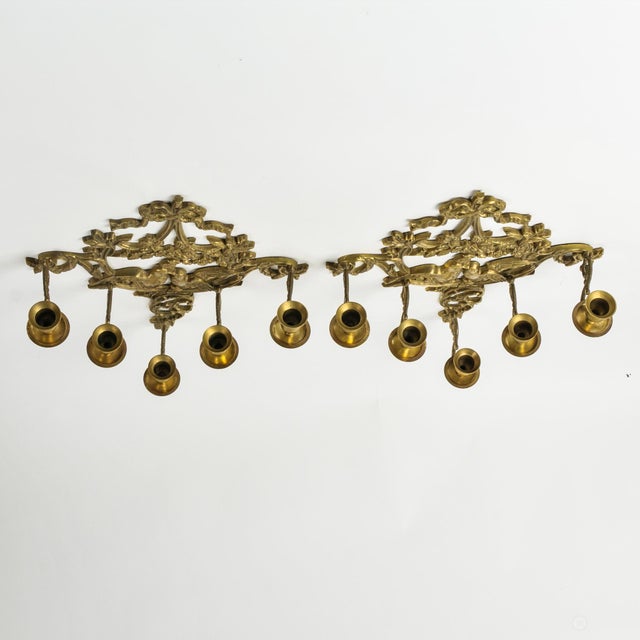 Incredible pair of vintage brass wall sconce candle holders in an epic five arm size featuring a lovely ornate bird,...