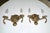Pair of European two-light neoclassic style brass wall sconces with dolphin and claim shell motif. Expertly crafted with...