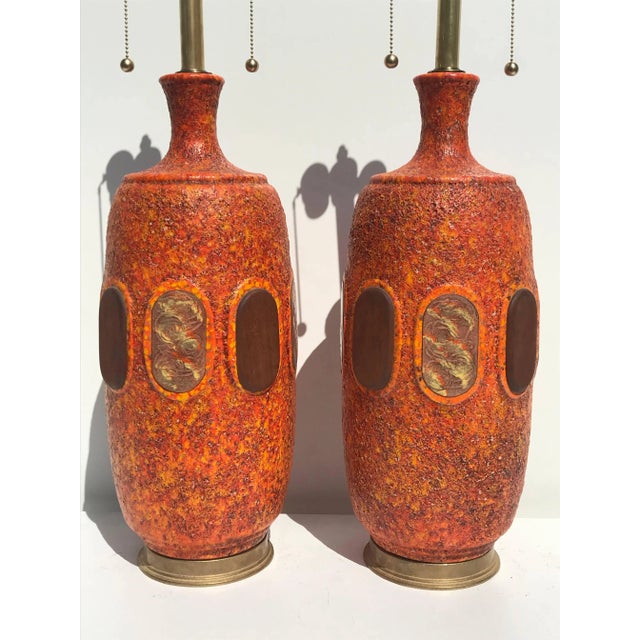 Pair of orange lava glazed ceramic lamps in the style of Marbro. Shades are not included. Offered at Gallery Girasole in...