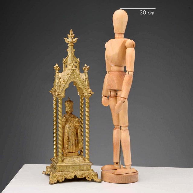 Infant Jesus of Prague in gilded metal. A small neo-Gothic temple housing a statue of the Infant Jesus of Prague rests on...