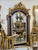 An extraordinary French Baroque style wall mirror featuring a richly carved gilded frame accented by striking royal blue...
