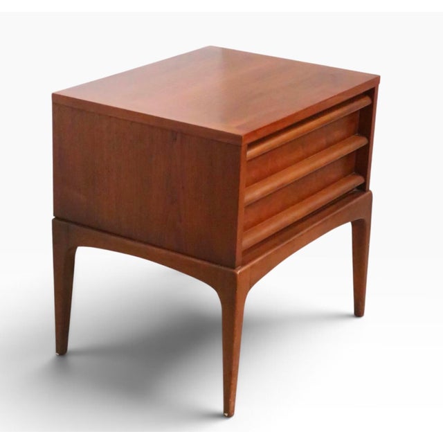 Classic mid century night table made by the Lane Furniture Company, as part of the sought after Rhythm series, circa...