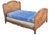 A striking antique French Provençal bed distinguished by its graceful serpentine form, hand-carved detailing, and...