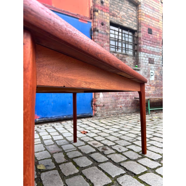 This extendable teak dining table by Henning Kjærnulf combines classic Danish mid-century design with exceptional everyday...