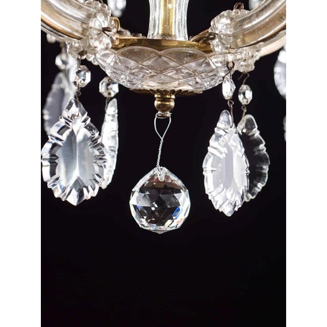Beautiful theresian-type chandelier. Polished brass body. Hand-cut crystal trimmings. The chandelier has 8 arms + one...
