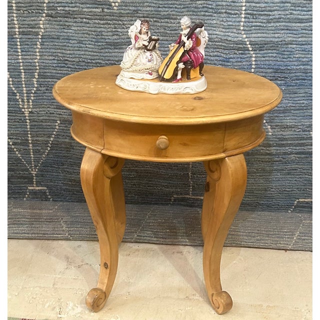 Vintage Oval accent table featuring elegan tcabriole legs with carved scroll details and a single functional drawer with a...