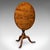 This is an antique tripod table. An English, oak and beech tilt-top side table, dating to the Georgian period, circa 1805....
