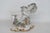 This charming Cherub Figurine is made of porcelain. This darling piece features an English Derby style cherub figure...