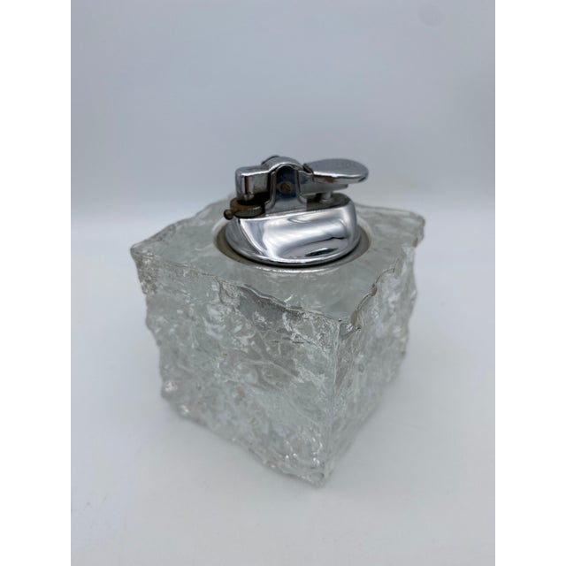 Ice cube-shaped mid-century glass table lighter. Excellent vintage condition without chips or cracks and a shiny chrome...