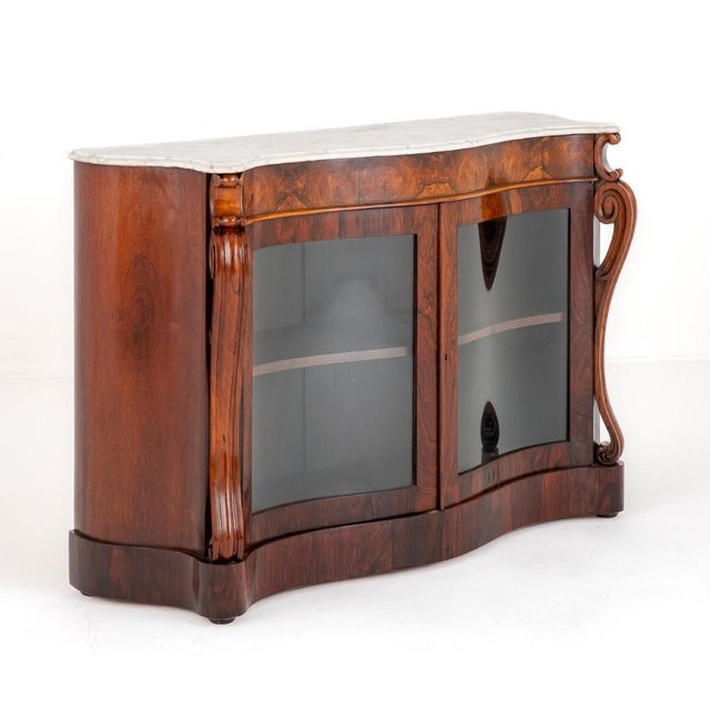 Victorian rosewood side cabinet. This impressive serpentine side cabinet stands upon a plinth base. The cabinet having 2...