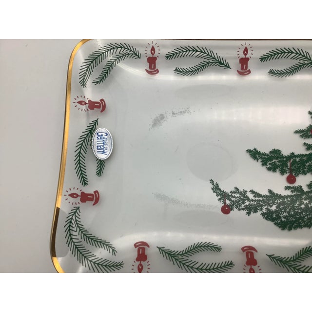 A lovely vintage serving platter that was made in Germany. The serving tray has a lovely gold rim, and a cute Christmas...