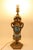 A captivating piece of late 19th-century French decorative art.This exquisite table lamp features a vibrant ceramic body...