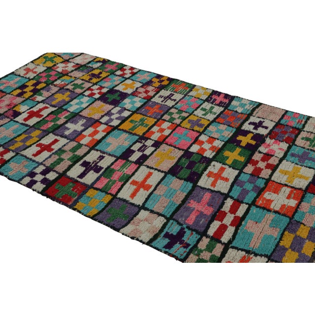 Hand-knotted in wool circa 1950-1960, this vintage 5x8 Moroccan rug is believed to hail from the Azilal tribe. On the...