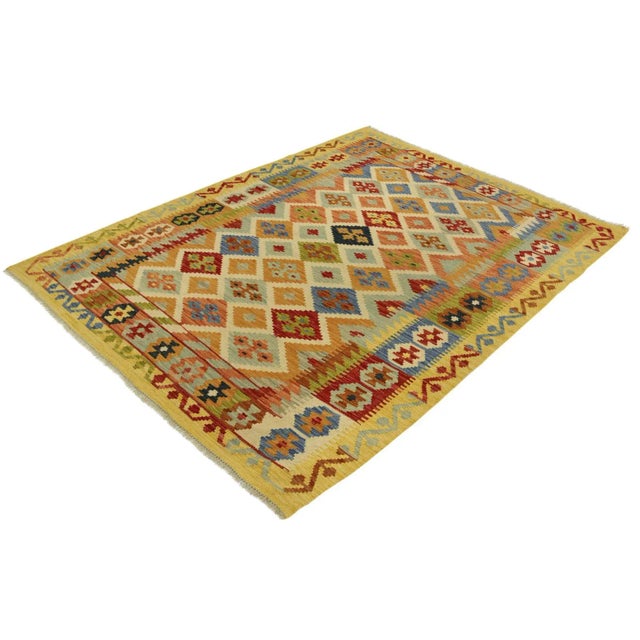 Add a touch of elegance to your home with this casual chic hand woven Tribal Kilim wool rug. Constructed on a loom by...