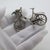 Delicate vintage miniature depicting a bicycle with a flower basket, handcrafted in Italy between the 1980s and 1990s in...