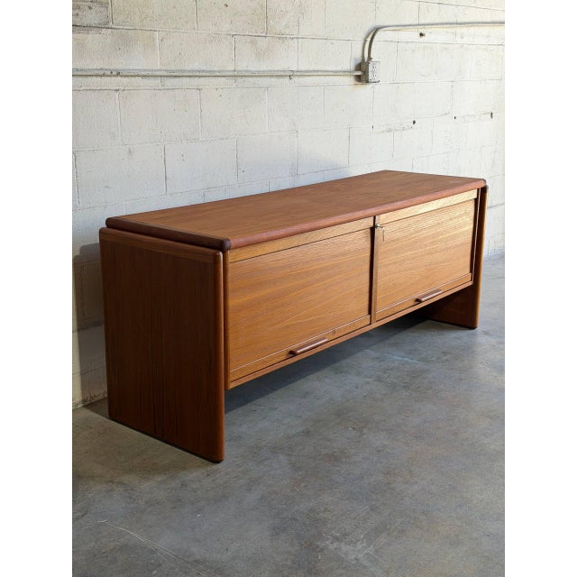 This low profile wooden sideboard features a clean rectangular form with two oversized pull-out drawers designed for...