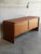 This low profile wooden sideboard features a clean rectangular form with two oversized pull-out drawers designed for...