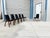 Mid-century walnut and black vinyl dining chairs, set of six, designed by Chet Beardsley and manufactured in the United...