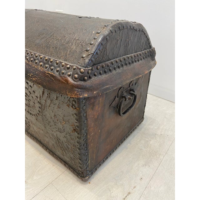 18 century leather dome top trunk in good condition… With brass nail heads and brass bail pulls at the sides… The front...