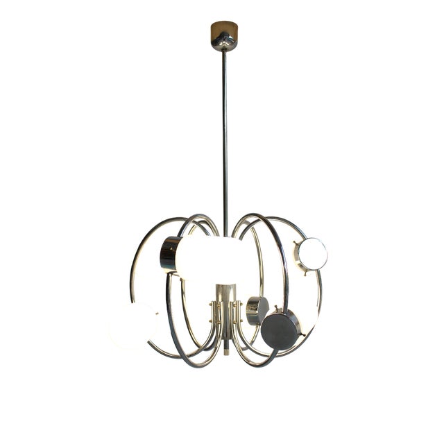 Impressive pendant lamp from the 1970s, crafted from a chrome-plated frame and opal glass globes/ domes. This lamp is a...
