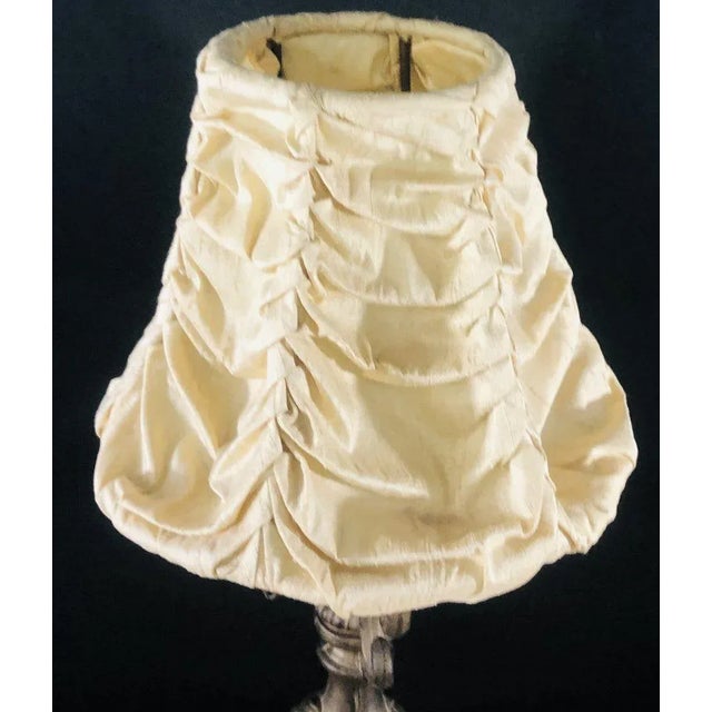 An 1940's Vintage small bronze finish table lamp with custom off white tufted shade. Dimensions (inches)- 17H x 8W x 8D...