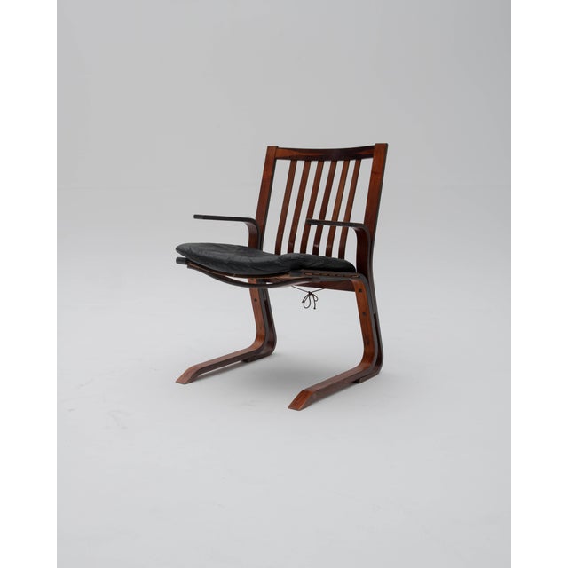 A set of two Scandinavian cantilever armchairs, designed in the style of renowned Norwegian designers Ingmar Relling and...