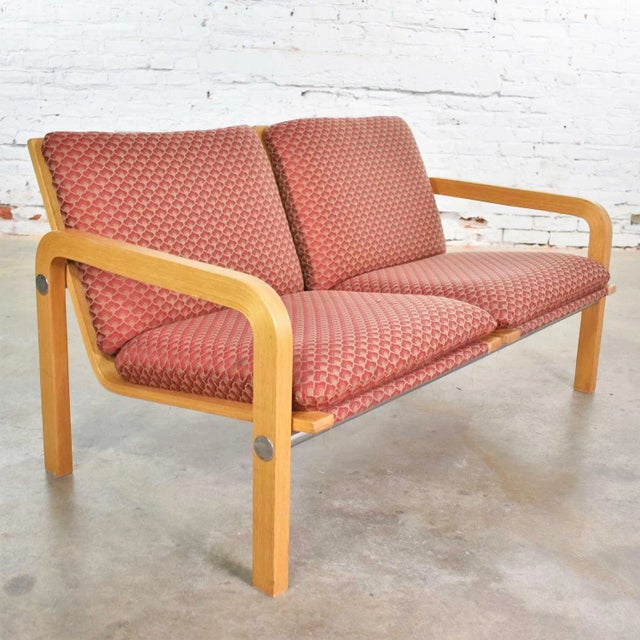 Handsome vintage modern two-seat settee or bench of oak bentwood, chrome, and upholstery attributed to Thonet. It is in...