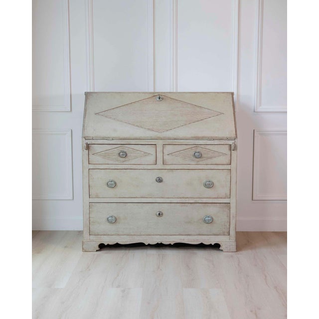 A refined Swedish Gustavian slant-front secretary from the early 19th century, presented in a beautifully aged original...