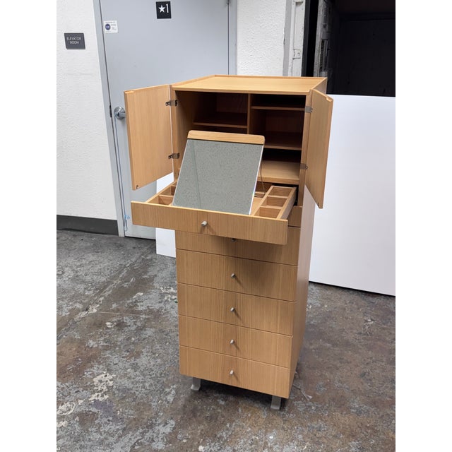 Design Plus Gallery presents a Light Oak Wood Jewelry Chest of Drawers by Jesse. The chest stands tall with a line upwards...