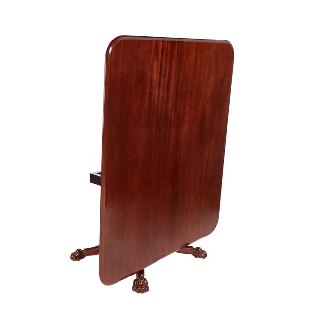 Large antique regency quality mahogany centre table having a quality figured mahogany tilt top with a moulded edge...