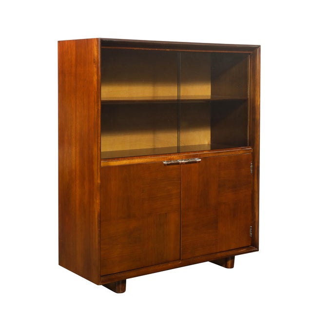 Elegant Art Deco Documented walnut cabinet designed by Gilbert Rohde circa 1939, showcasing his signature blend of...