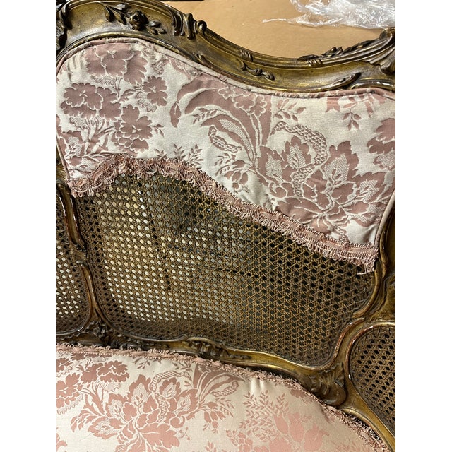 Antique settee with beautiful soft pink and tan floral fabric. Romantic details and beautiful workmanship