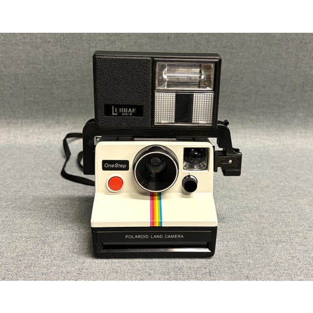 A fun and colorful rainbow stripe Polaroid One Step Land camera with flash. Have fun with this 1970s camera with instant...