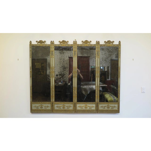 A 19th century Italian mirror panel. 19th century panel screen mirror. Four Paneled screens of carved, painted, and gilded...