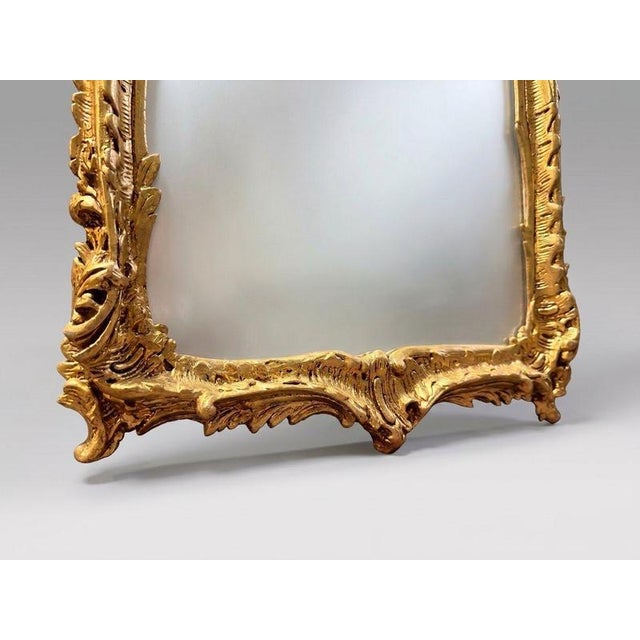 A wonderfully detailed French-style mirror with exceptional depth and intricate craftsmanship. Decorated with rich rococo...