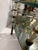 Stunning mid-century Hollywood Regency-style two-tier coffee table featuring ornate faceted crystal/lucite column supports...