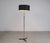 Metal floor lamp, possibly produced in Germany in the 1960s. The lamp is made of metal with a cast iron tripod and a black...
