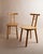 This vintage wooden chair from the 1980s features a minimalist design with light wood and a timeless form, inspired by...