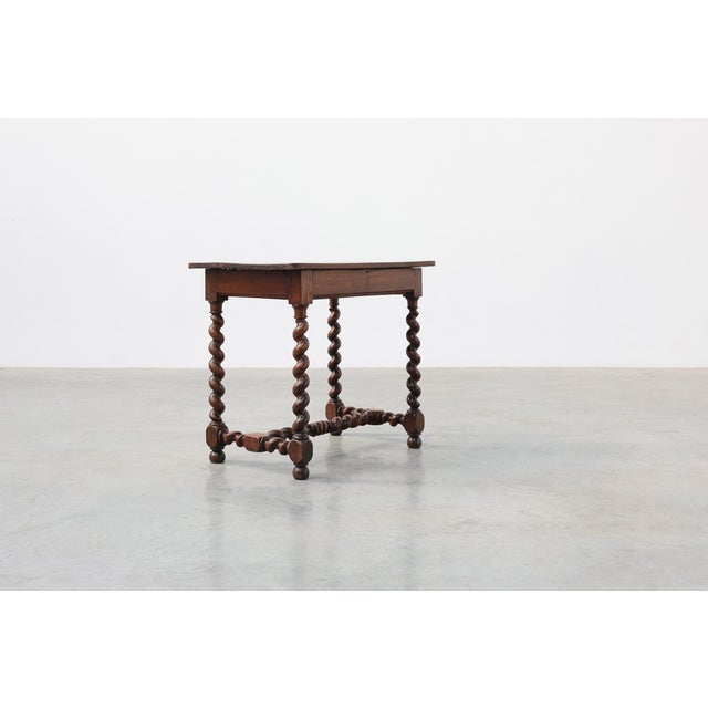 A charming French walnut side table dating to the late 19th century, distinguished by its beautifully turned barley twist...