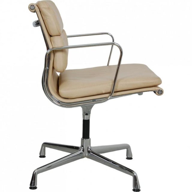 Charles Eames Ea-208 softpad chair upholstered with beige leather on the back and front. The chair is from 2007 and...