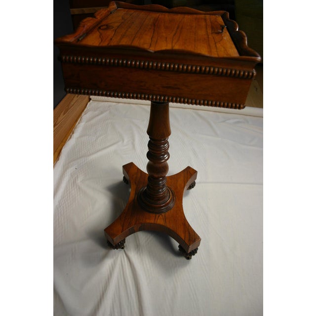 A refined mid-19th century Victorian teapoy, crafted in beautifully grained rosewood and raised on a turned central...