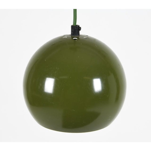 A 1960's pair of Danish aluminum globe pendant lights in an olive-green finish. The wiring cord is also olive-green. The...