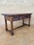 This Spanish low table dates from the 20th century, circa 1930, and is crafted in solid walnut. The piece features a...