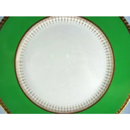 No chips nor cracks Crazing all over, with obvious stained crazing in center off white area Green and gold are vibrant and...